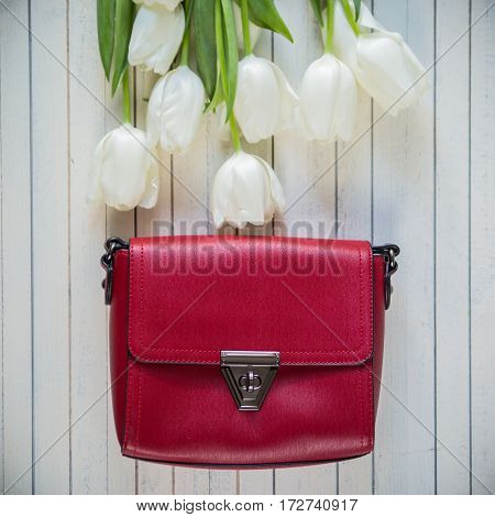 pink woman bag with flowers on wood background