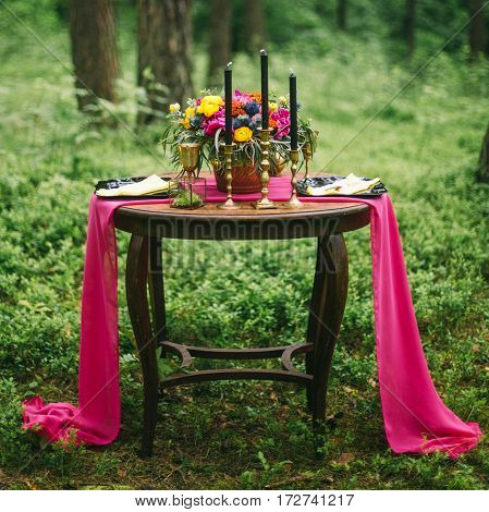 Close Up Of White Vintage Candelabrum On The Wedding Decorated Table In The Forest. Bouquet Of Pink