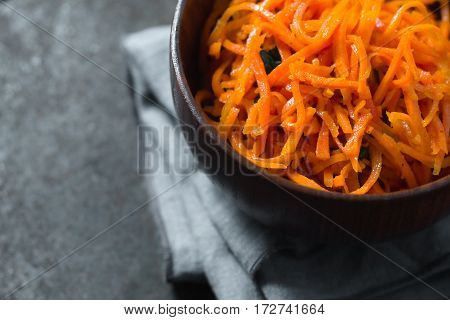 Carrots in Korean with spices on a metal table partial blur horizontal
