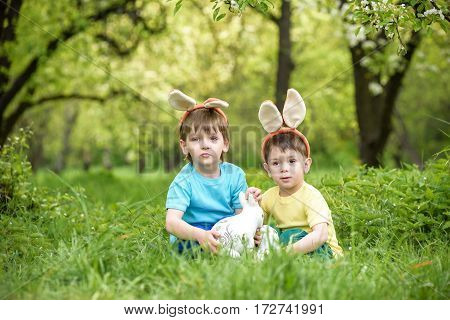 Two Little Kids Boys And Friends In Easter Bunny Ears During Tra