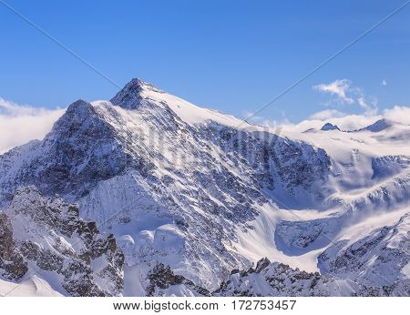 Alps, view from Mt. Titlis in Switzerland in winter. The Titlis is a mountain, located on the border between the Swiss cantons of Obwalden and Bern.