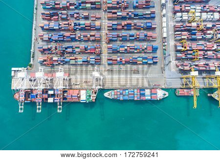 container ship in import export and business logistic. By crane Trade Port Shipping. Tugboat assisting cargo to harbor. Aerial view.