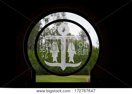 GALILEE ISRAEL - DECEMBER 3: The Round window with anchor and fish symbols above the entrance in Domus Galilaeae on the Mount of Beatitudes near the Sea of Galilee Israel on December 3 2016
