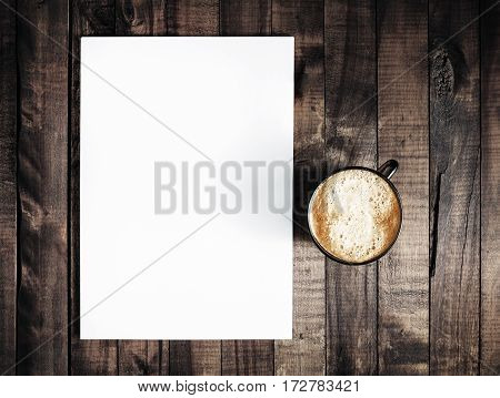 Blank letterhead and coffee cup on vintage wooden table background. Blank branding template. Blank stationery. Mockup for branding identity for placing your design. Top view.. Top view.