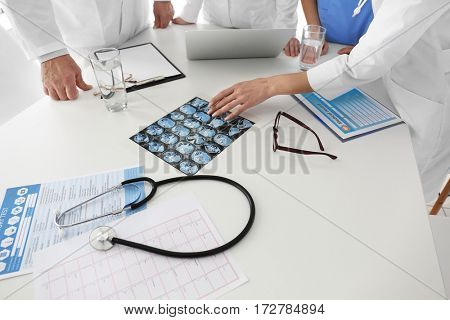 Team of doctors exploring roentgenogram in clinic