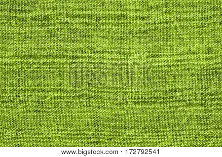 Homespun hemp cloth. Close-up of texture fabric cloth textile background. Homespun hemp fabric material. Homespun hemp canvas. Natural authentic cloth. Lime green color