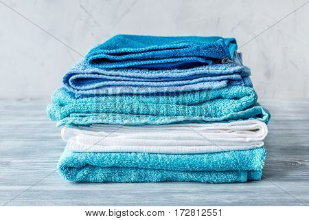 Blue towels set in laudry on gray table backgruond