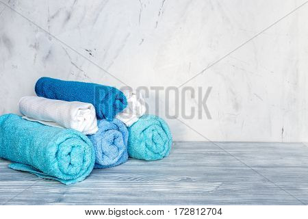 blue towels pile in housekeeping set on laudry gray background mockup