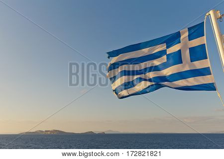 Flag of Greece Flying in Wind and Blue Sunny Sky