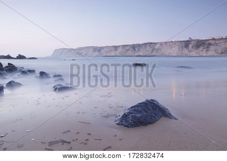 Serene seascape in Arrigunaga beach Biscay Basque Country Spain. Long exposure on a misty sunset.
