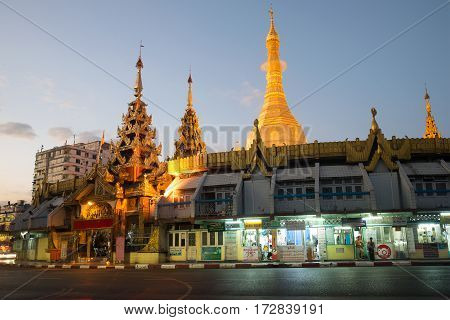 YANGON, MYANMAR - DECEMBER 18, 2016: At the entrance to the Sule pagoda in the evening twilight