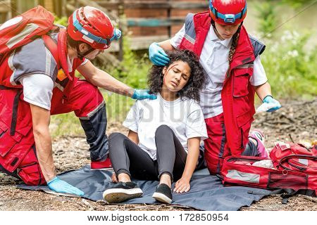Rescue team helping injured victim, color image