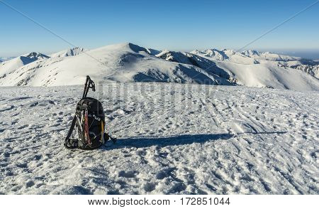 Backpack With Ice Axes And Trekking Poles In Winter In The Mountains.