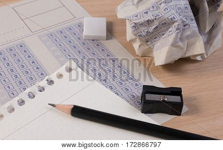 Crumpled Paper Ball Of Vintage Classic Answer Sheet With Pencil, Sharpener And Paper Reduction. Cros