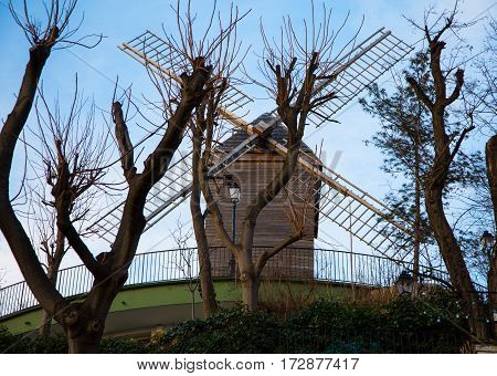 The windmill Radet on Montmartre hill built in 1717 Paris France. French landmarks and travel destination concept.
