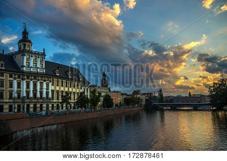 Wroclaw view: river Oder (or Odra) and University of Wroclaw against beautiful evening sky with clouds.