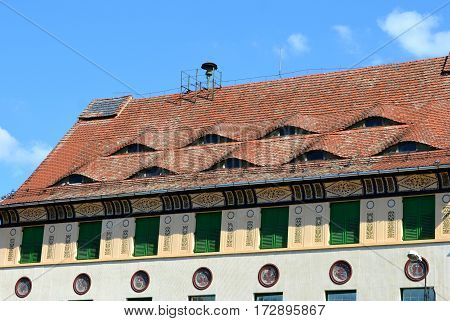 Eyed roof. Urban landscape in the downtown of the medieval city Sighisoara, Transylvania.