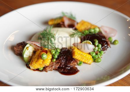 Pulled pork with grilled vegetables and potato mash, close-up