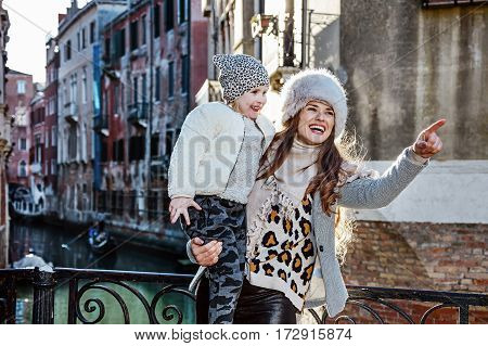 Mother And Daughter Travellers In Venice Pointing At Something