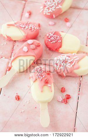 Chocolate covered Vanilla ice cream pops with sugar sprinkles