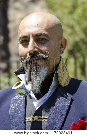 CAGLIARI, ITALY - May 29, 2016: Sunday at La Grande Jatte VIII Ed. At the Public Gardens - Sardinia - portrait of a man in Victorian costumes