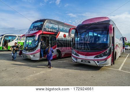 Menumbok,Sabah-Aug 19,2016:People running up to the bus in bus terminal at Menumbok,Sabah.People used to take bus from Kota Kinabalu to Menumbok then ferry to Labuan island to enjoy tax free shopping