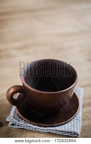 Empty Clay Cup on Wooden Background. Home Wares. Kitchen Decor in Rustic Style. View From Above With Copy Space.