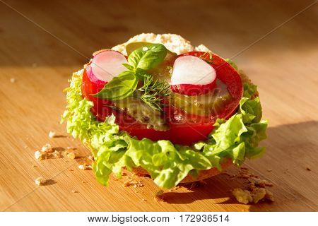 Sandwich with tomato lettuce cucumber and basil