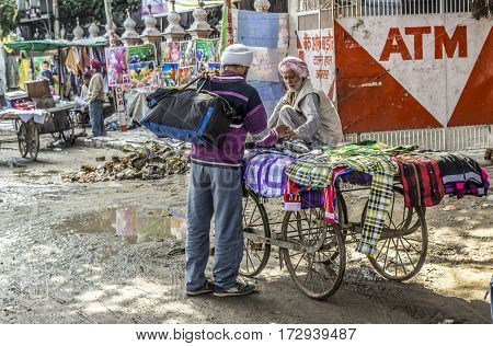 Old Hawker Sells Clothes  At The Flooded Street In Rainy Season