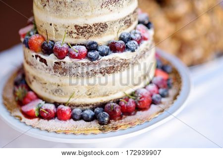 Delicious Chocolate Wedding Cake Decorated With Fruits And Berries