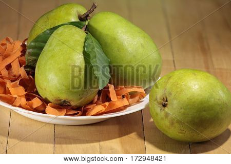 large ripe pears in the plate on the table