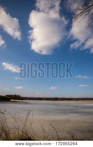 Early Spring Scene Of Frozen Fishpond
