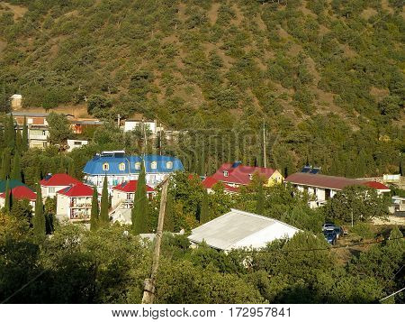 Multi-colored roofs on a background of mountains.