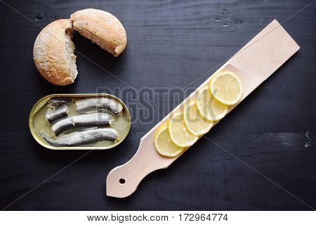 metal can with conserved herring fish, canned marinated herring,  open tin can , Top view.
