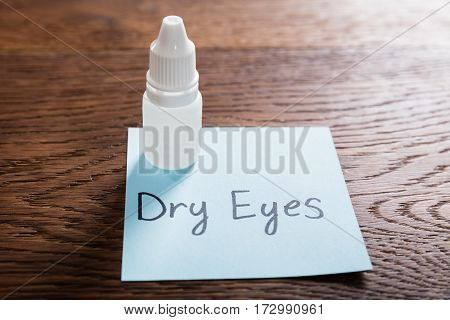 Dry Eyes Concept With Eye Drops On Wooden Desk