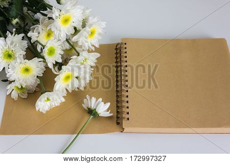 Blank area note book or diary with flower