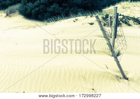 Stunning Mangawhai Heads sand dunes with old fence in split tone