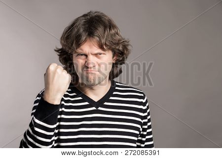 Furious Outraged Caucasian Man Threaten In Anger, Frowns His Face, Keeps Fist Going To Defend Himsel