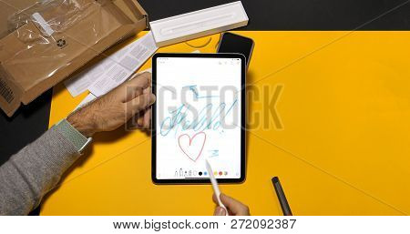 Paris, France - Nov 16, 2018: Man Writting Hello Word On Latest Ipad Pro Smart Tablet Device And App