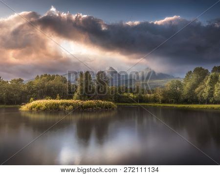 Strba Lake Under The  Peaks Of High Tatras Mountains Lit By Golden Light At Sunset