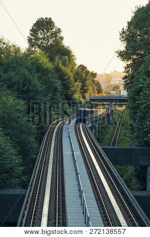 City Skyline Of Vancouver Bc, With Sky Train Looking Towards Downtown During A Summer Sunset