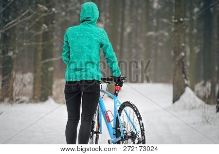 Cyclist On Cyclocross Bike Trails In The Snowy Forest In Winter. Winter Workout Outdoors Concept