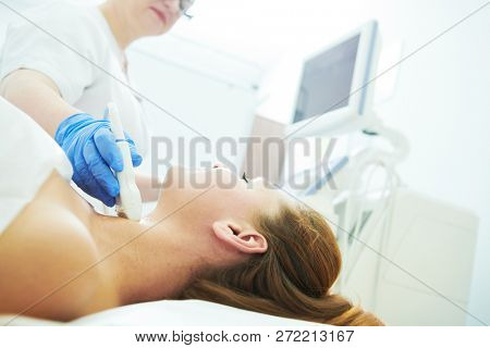 ultrasound scan. Examining the thyroid gland of female patient
