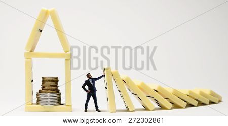The Man Stops The Fall Of Dominoes. Metaphor Of Crisis Management.