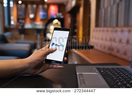 Chiang Mai, Thailand - May 05,2018: Man Holding Huawei With Paypal Apps On The Screen. Paypal Is An 
