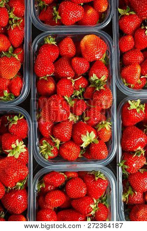 Close Up Of Fresh Red Ripe Strawberries In Transparent Plastic Container Boxes On Retail Market Disp