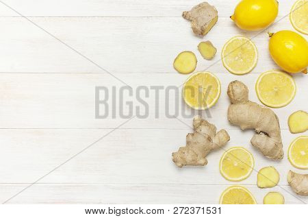Fresh Ginger Root And Lemon On White Wooden Background. Flat Lay, Top View, Copy Space. Minimalistic