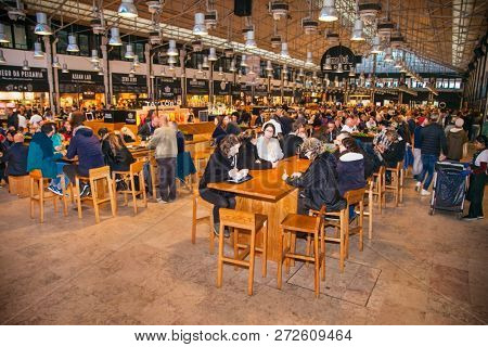LISBON, PORTUGAL - OCT 30, 2018, 2018: People eat at TimeOut Market in Lisbon, Portugal. TimeOut Market is a unique attempt to bring all best restaurants in Lisbon at one place.