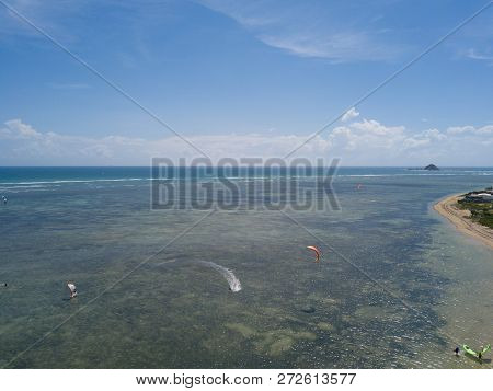 Kiteboarding, Kite Surf. Extreme Sport Kitesurfing In Tropical Blue Ocean, Clear Beach. Aerial Views
