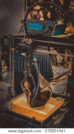 3d Printer Printing A Model In The Form Of Black Vase Close-up.
